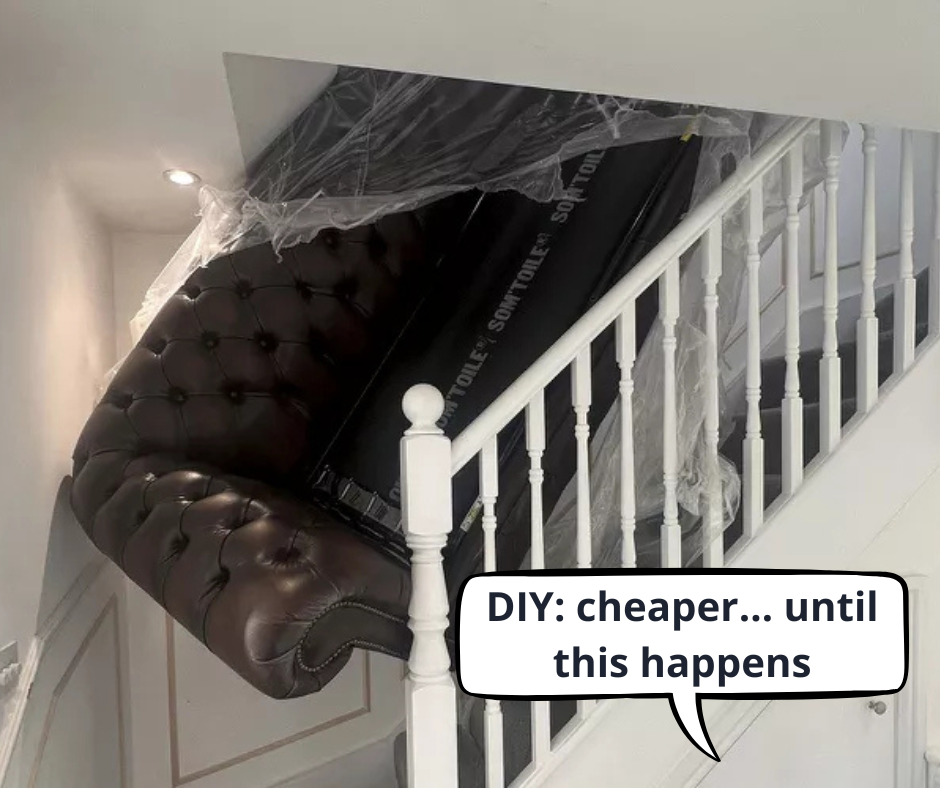 Large leather sofa wedged on a narrow staircase during a DIY house move