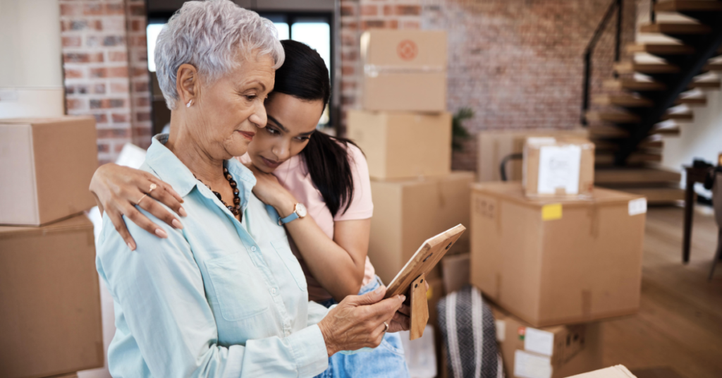 Adult daughter helping elderly mother prepare for moving home in Dorset.