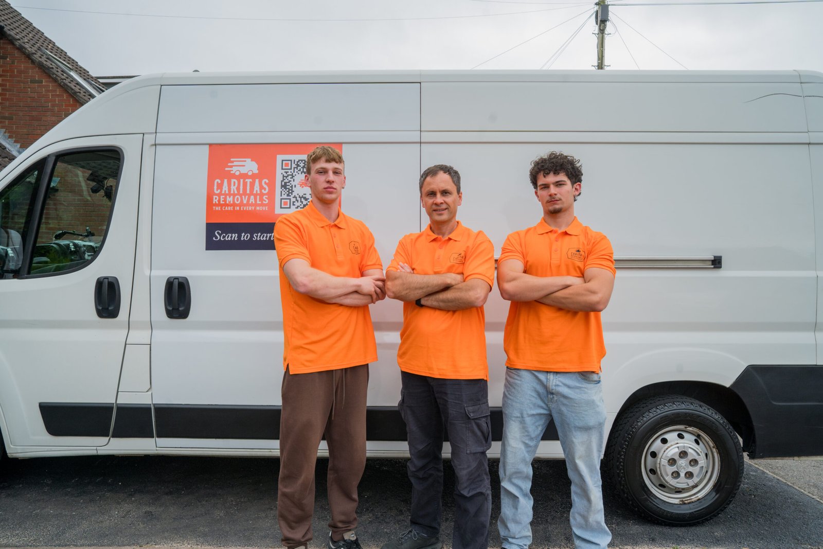 Caritas Removals team standing in front of their removals van in Poole