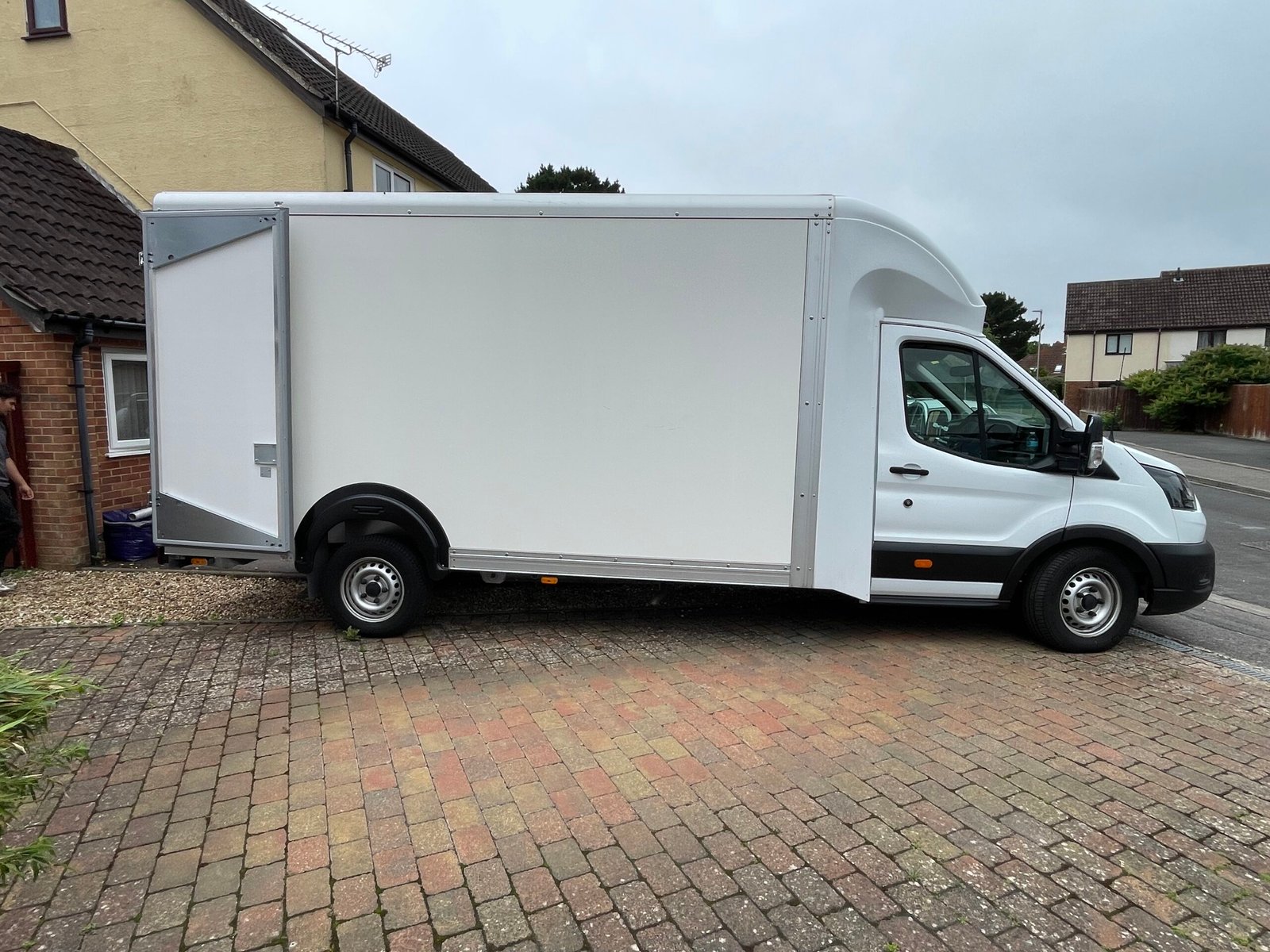 Luton removals van parked outside a home for a house move in Christchurch