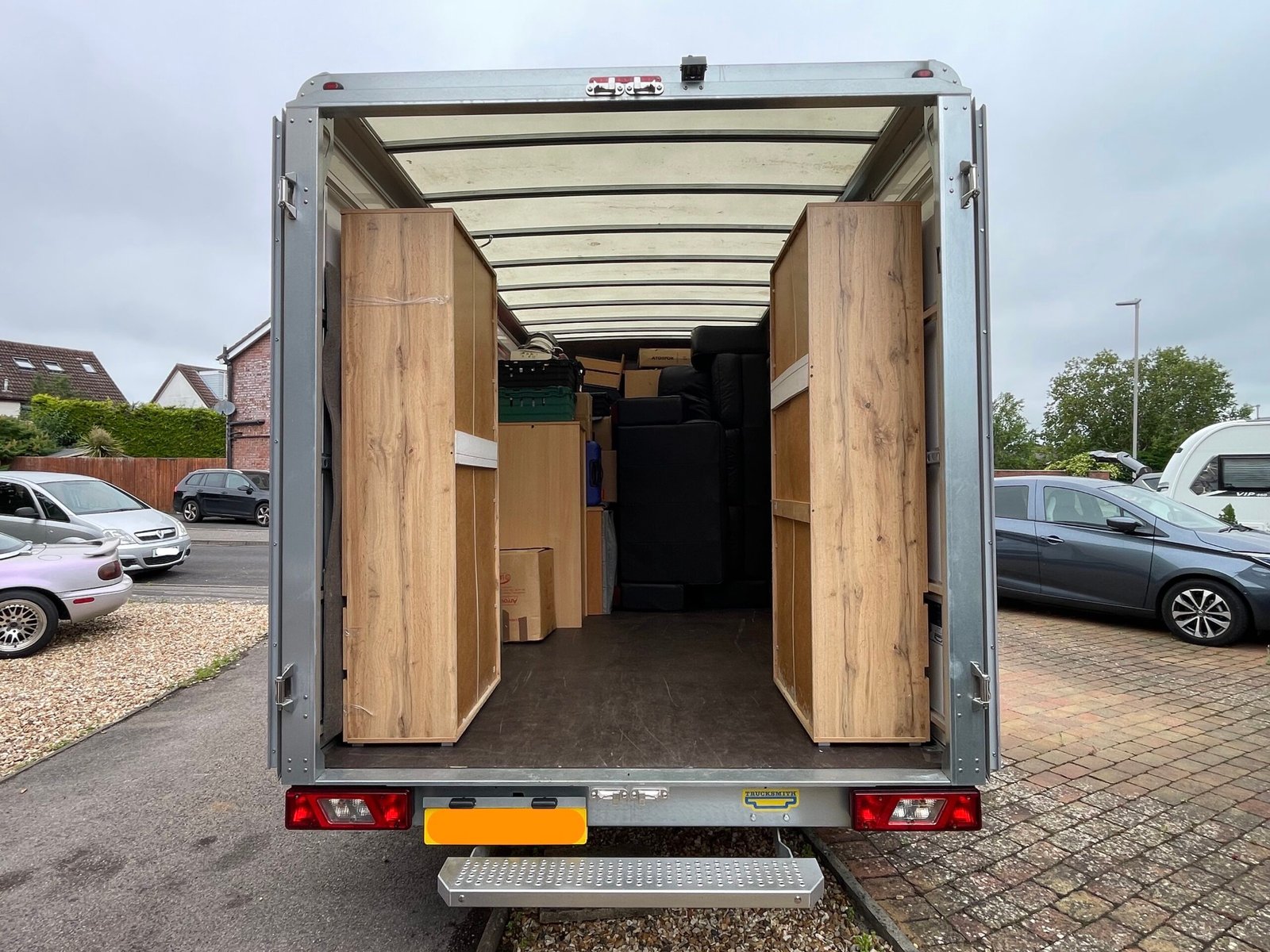 Loaded removals van with furniture, wardrobes and boxes for a house move