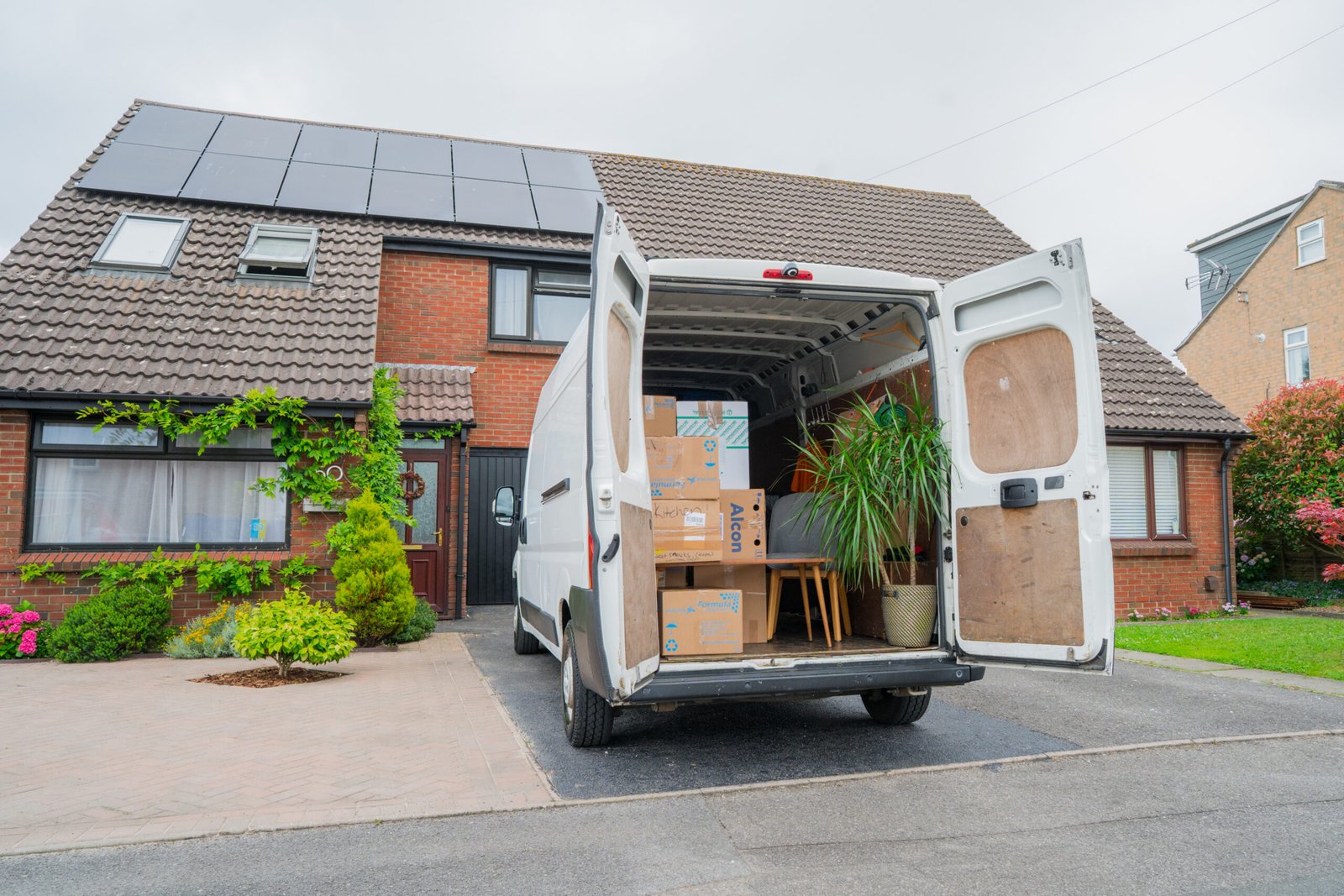Man and van loaded with boxes and household items outside a Bournemouth home