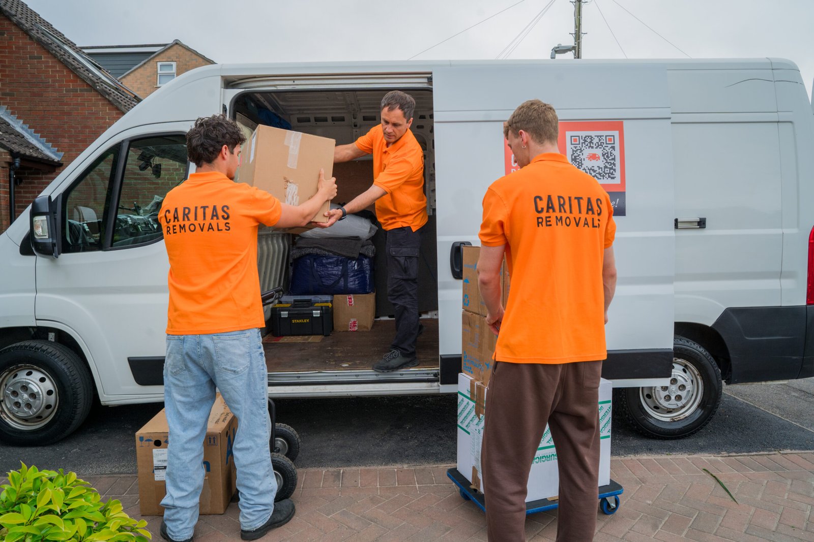 Caritas Removals team loading boxes into a van for a Man and Van move in Christchurch