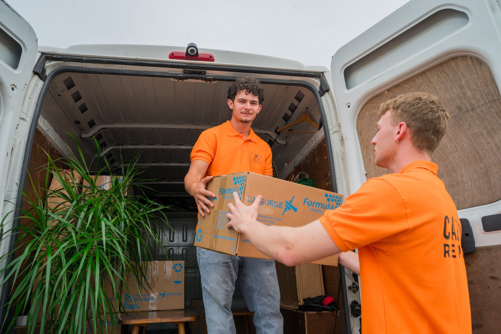 Caritas Removals team loading boxes into a van for a Man and Van move in Poole