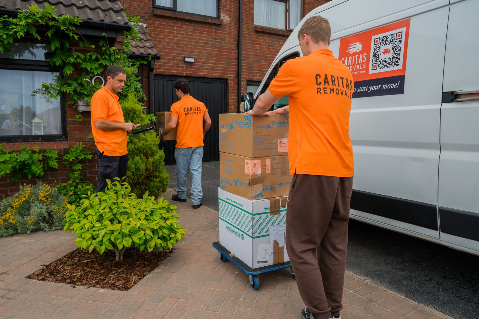 Caritas Removals team loading boxes into a removal van during a move in Poole