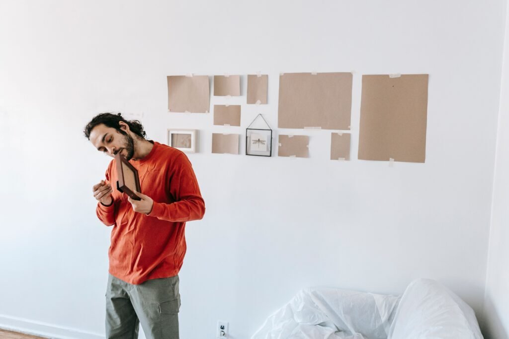 Couple removing picture frames while preparing for a move